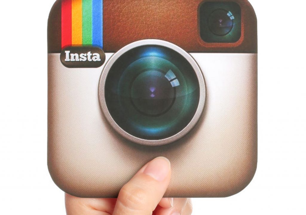 45701265 - kiev, ukraine - april 29, 2015:hand holds instagram logotype printed on paper. instagram is an online mobile photo-sharing, video-sharing service.